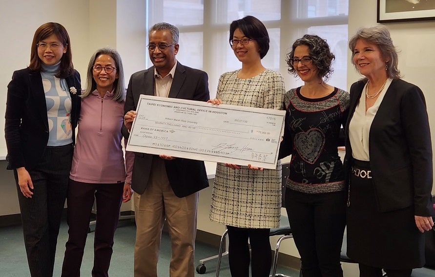 Director General Yvonne Hsiao presents the check to Dr. Ramesh and Dr. Santos